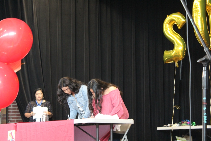 Fernanda Stewart and Ebelin Silva are signing to their post-secondary plans. They walked down the aisle together.